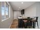 Basement wet bar with a modern countertop and two barstools at 8695 Torrey St, Arvada, CO 80007