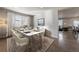 Formal dining room with a marble table, six chairs, and a view to the living room at 8695 Torrey St, Arvada, CO 80007