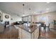 Open floor plan with kitchen island, living room and dining area at 8695 Torrey St, Arvada, CO 80007