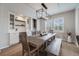 Elegant dining area with a rustic table, stylish lighting, and built-in cabinets at 10702 Sundial Rim Rd, Highlands Ranch, CO 80126