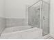 Bright bathroom features a soaking tub and a glass enclosed shower at 19 S Harrison St, Denver, CO 80209