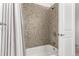 Bathroom features tile shower/tub, and white door at 19 S Harrison St, Denver, CO 80209