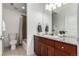 Well-lit bathroom with wood cabinets and granite countertop at 19 S Harrison St, Denver, CO 80209