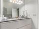 Bright bathroom featuring a double sink, large mirror, and white cabinets at 19 S Harrison St, Denver, CO 80209