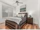 Cozy bedroom features hardwood floors, a ceiling fan, and large window at 19 S Harrison St, Denver, CO 80209
