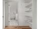 Hallway with shelving leading to a bright bathroom with tiled floors at 19 S Harrison St, Denver, CO 80209
