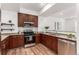 Well-equipped kitchen featuring stainless steel appliances, granite countertops, and wooden cabinetry at 19 S Harrison St, Denver, CO 80209