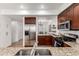 Modern kitchen with stainless steel appliances, granite countertops, and ample cabinet space at 19 S Harrison St, Denver, CO 80209