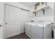 Laundry room with front-loading washer and dryer and white storage at 19 S Harrison St, Denver, CO 80209