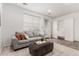 Bright living room features a plush sofa, ottoman, and ample storage at 19 S Harrison St, Denver, CO 80209