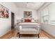 Bright bedroom features wood floors, large windows, white walls, and a decorative bench at 19 S Harrison St, Denver, CO 80209