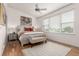 Bright bedroom features hard wood floors, a ceiling fan, and windows that let in plenty of natural light at 19 S Harrison St, Denver, CO 80209