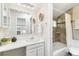 Bathroom features a modern vanity, mirror with lights and tub shower at 1842 Canyon Blvd # 209, Boulder, CO 80302