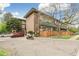 Exterior view of the building featuring wood fencing and various green trees at 1842 Canyon Blvd # 209, Boulder, CO 80302