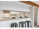 Kitchen featuring bar stool seating, wooden beam, and open layout at 1842 Canyon Blvd # 209, Boulder, CO 80302