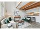 Bright living room boasts wood beams, accent chairs, and easy kitchen access at 1842 Canyon Blvd # 209, Boulder, CO 80302