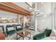 Open living area with wood beam ceilings and a unique spiral staircase at 1842 Canyon Blvd # 209, Boulder, CO 80302
