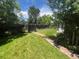 Beautifully landscaped backyard featuring a brick-lined walkway and lush greenery at 701 S Clayton St, Denver, CO 80209