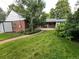 Spacious backyard features mature landscaping, a manicured lawn, and stone pathway to the patio at 701 S Clayton St, Denver, CO 80209