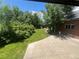 Charming backyard with stone patio, brick accents, and lush green lawn at 701 S Clayton St, Denver, CO 80209