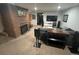 Finished basement featuring a brick fireplace, TV, and comfortable seating area at 701 S Clayton St, Denver, CO 80209