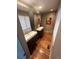 Modern bathroom featuring floating vanities, large mirrors, wood floors, and a striking art piece at 701 S Clayton St, Denver, CO 80209
