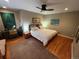 Comfortable bedroom with hardwood floors and stylish decor, featuring a ceiling fan and natural light at 701 S Clayton St, Denver, CO 80209