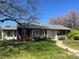 Charming brick home featuring manicured front lawn and inviting front entrance with updated windows at 701 S Clayton St, Denver, CO 80209