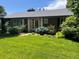 Charming brick home with well-maintained lawn and mature landscaping, creating inviting curb appeal at 701 S Clayton St, Denver, CO 80209