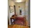 Inviting foyer with hardwood floors, stylish rug, and decorative table at 701 S Clayton St, Denver, CO 80209