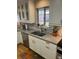 Modern kitchen featuring white cabinets, herringbone backsplash, and stainless steel appliances at 701 S Clayton St, Denver, CO 80209