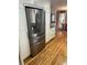Spacious kitchen with stainless steel refrigerator, white cabinets, and hardwood floors at 701 S Clayton St, Denver, CO 80209