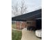 Brick home featuring covered patio and manicured lawn at 701 S Clayton St, Denver, CO 80209