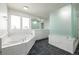 Bright bathroom with a marble topped soaking tub, walk in shower, and double vanity at 301 Amethyst Way, Superior, CO 80027