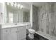 Modern bathroom featuring an updated shower with gray tile and a single sink vanity at 301 Amethyst Way, Superior, CO 80027