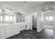 Bright bathroom with a double vanity, updated fixtures and a walk-in closet at 301 Amethyst Way, Superior, CO 80027