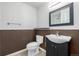 Half bathroom with sink, toilet, and wainscotting at 301 Amethyst Way, Superior, CO 80027