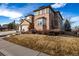 A low angle shows the two-story home with a three-car garage, fountain and winter lawn at 301 Amethyst Way, Superior, CO 80027