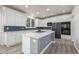 Bright kitchen featuring white cabinets, gray island, stainless steel appliances, and lots of lighting at 301 Amethyst Way, Superior, CO 80027