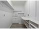 A white laundry room with sink and shelving at 301 Amethyst Way, Superior, CO 80027