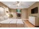 Relaxing main bedroom with a fireplace and tvs, a king size bed, and great natural light at 301 Amethyst Way, Superior, CO 80027