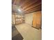 Unfinished basement with exposed wood beams, wooden shelves and cabinet offers a blank canvas for customization at 13024 E Alaska Pl, Aurora, CO 80012