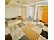 Spacious finished basement with multi-colored carpet tiles and a neutral wall color at 13024 E Alaska Pl, Aurora, CO 80012