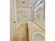 Bright bathroom featuring a shower-tub combo, neutral tile flooring, and ample counter space at 13024 E Alaska Pl, Aurora, CO 80012