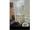 Cozy bathroom features a white vanity, mirror and toilet, perfect for a small space at 13024 E Alaska Pl, Aurora, CO 80012
