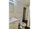 Compact bathroom featuring a white vanity, toilet, and essential fixtures at 13024 E Alaska Pl, Aurora, CO 80012
