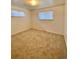 A bedroom features neutral walls, carpeted floors and bright natural light from two windows at 13024 E Alaska Pl, Aurora, CO 80012