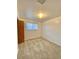 A bedroom with carpeted floors features a window for natural light and a door at 13024 E Alaska Pl, Aurora, CO 80012