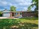 Charming brick home with a well-maintained lawn and attached two-car garage at 13024 E Alaska Pl, Aurora, CO 80012