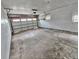 Clean and open garage space with a roll-up door, ready for parking or projects at 13024 E Alaska Pl, Aurora, CO 80012